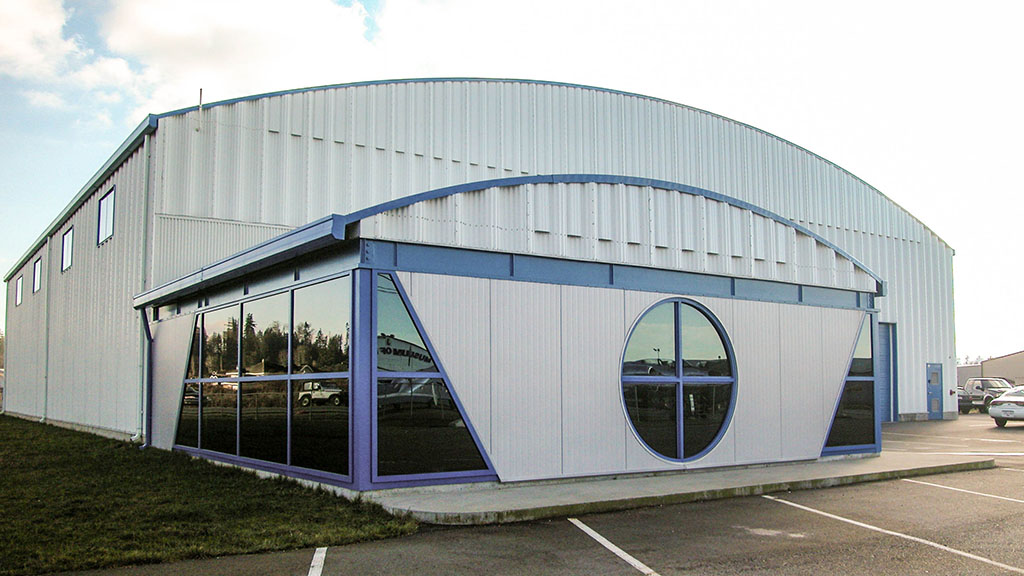 U-Build Frameless Steel Buildings are aesthetically pleasing. They can be finished with our cladding which is available in a variety of colors, or nearly limitless other options such as brick, stucco, glass, or block. This helicopter hangar is finished with metal cladding.