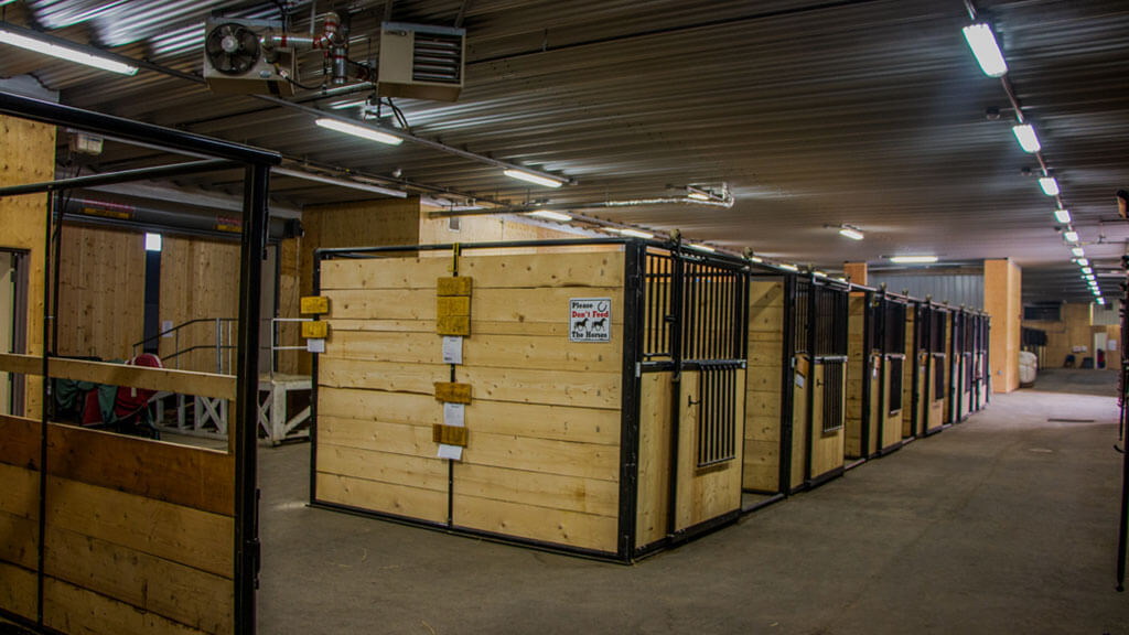 U-Build Indoor stables directly attached to an indoor riding arena.