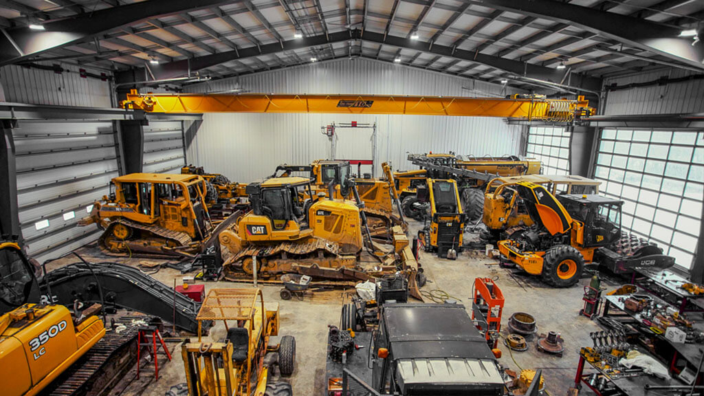 U-Build This interior shot of a heavy duty equipment workshop demonstrates the use of a crane in a U-Build Steel building.